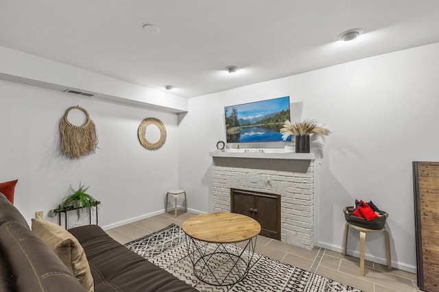 living room featuring a stone fireplace