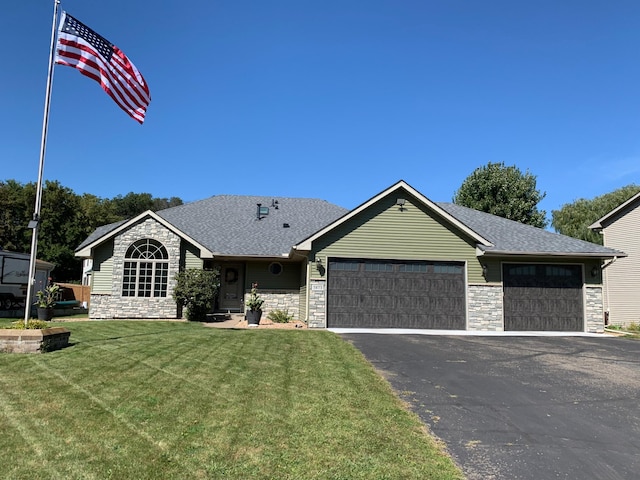 single story home featuring a garage and a front lawn