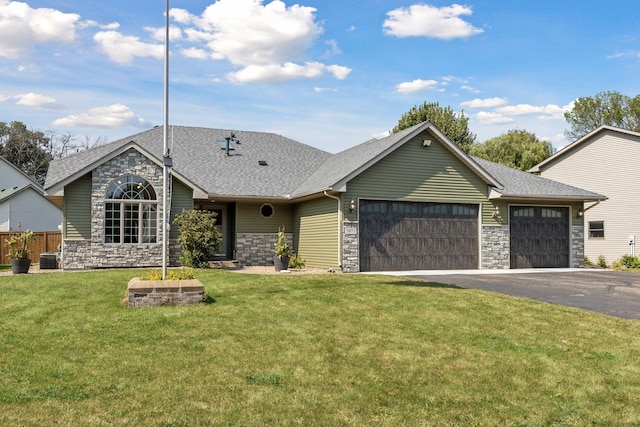 single story home featuring a front yard and a garage