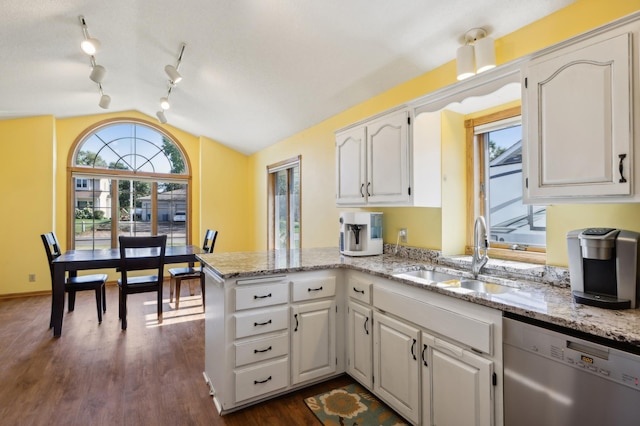 kitchen featuring stainless steel dishwasher, white cabinetry, sink, and kitchen peninsula