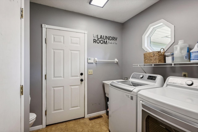 clothes washing area featuring separate washer and dryer