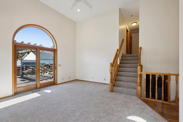 carpeted spare room with ceiling fan