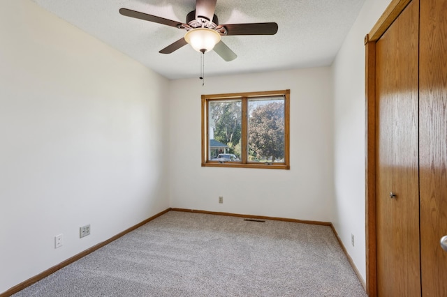 unfurnished bedroom featuring light carpet and ceiling fan