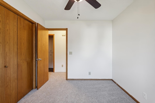 bedroom featuring a closet, light carpet, and ceiling fan