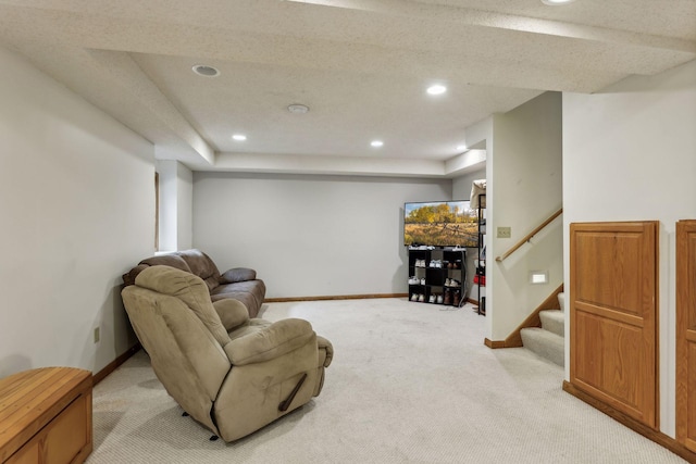 living room featuring light carpet and a tray ceiling