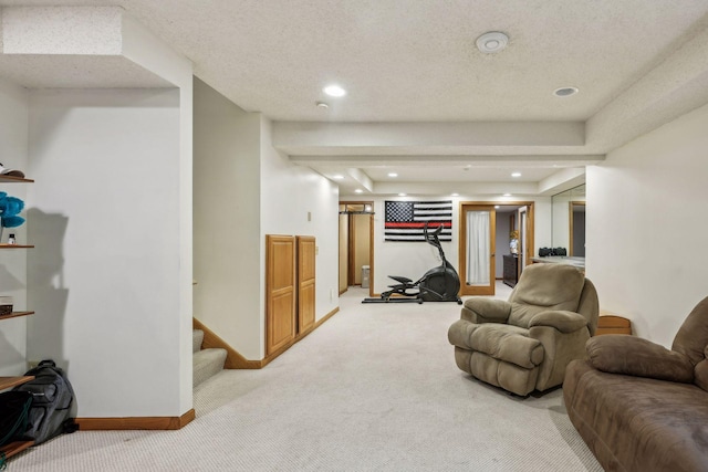 living room featuring a textured ceiling, a tray ceiling, and light carpet