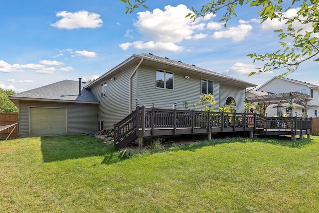 rear view of house with a lawn, a pergola, a garage, and a wooden deck