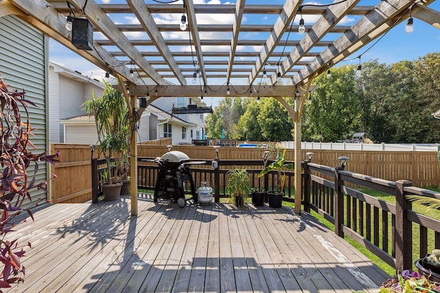 deck with grilling area and a pergola