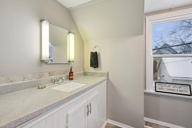 bathroom featuring vanity and vaulted ceiling