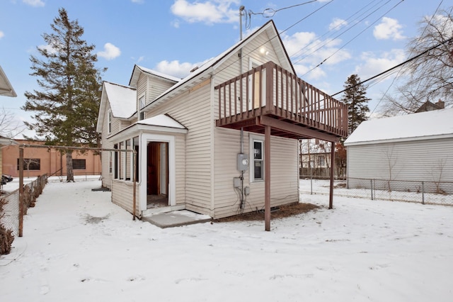 snow covered property featuring a deck