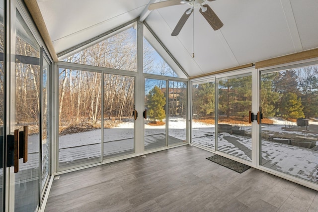 unfurnished sunroom featuring ceiling fan, lofted ceiling, and plenty of natural light