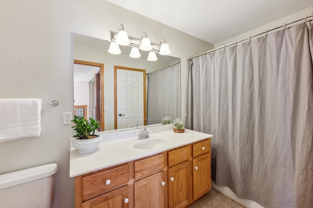 bathroom featuring vanity, tile patterned floors, and toilet