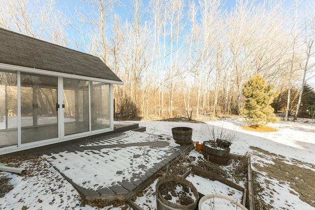 snow covered patio with a sunroom