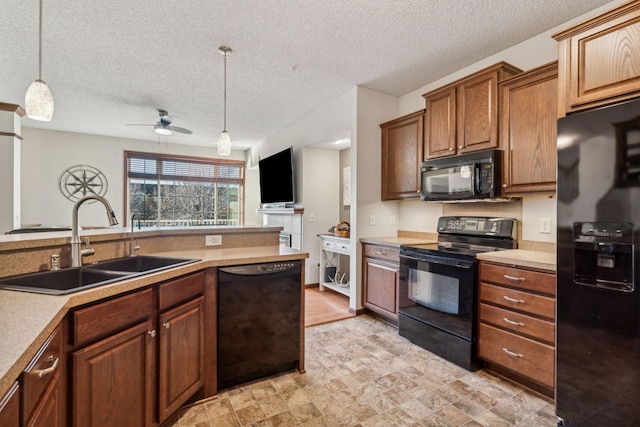 kitchen featuring a textured ceiling, ceiling fan, sink, black appliances, and pendant lighting