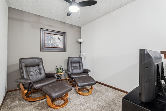 sitting room with carpet flooring, ceiling fan, and a textured ceiling