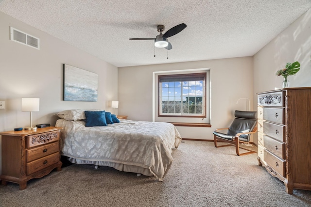 bedroom featuring carpet, ceiling fan, and a textured ceiling