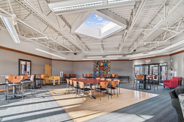 dining space with a wealth of natural light, crown molding, and wood-type flooring