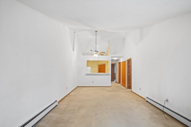 carpeted empty room with ceiling fan, high vaulted ceiling, and a baseboard radiator