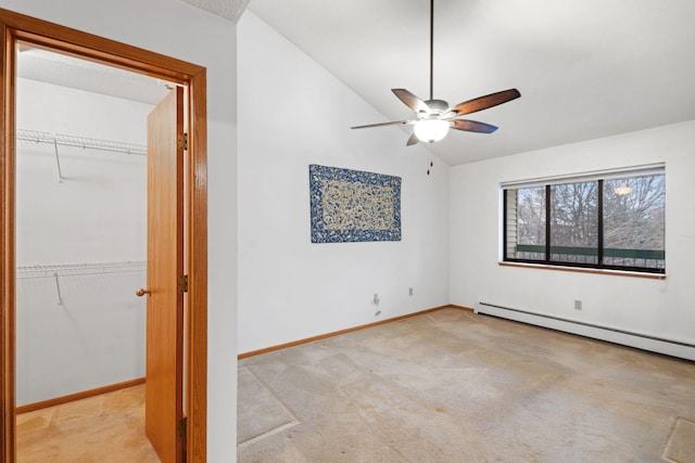 carpeted spare room with ceiling fan, lofted ceiling, and baseboard heating