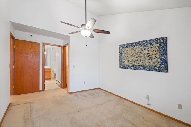 carpeted empty room with baseboard heating, ceiling fan, and vaulted ceiling