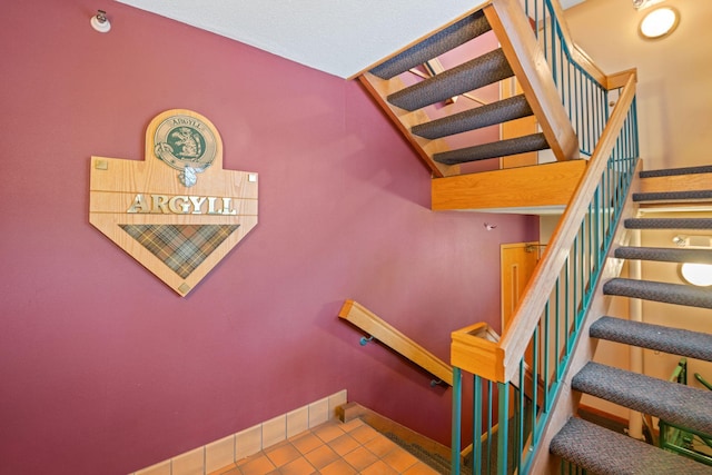 stairway featuring tile patterned flooring