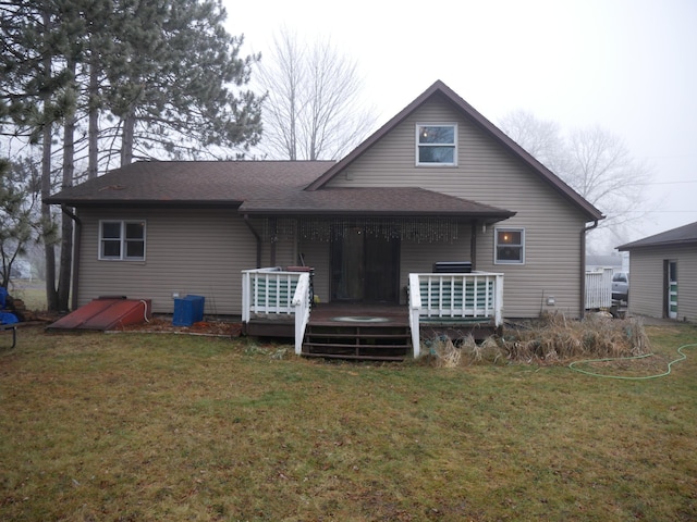 back of house with a deck and a lawn