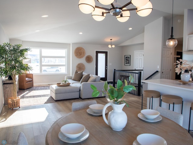 dining space featuring vaulted ceiling, ceiling fan, plenty of natural light, and light hardwood / wood-style flooring