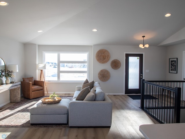 living room featuring vaulted ceiling and light hardwood / wood-style floors