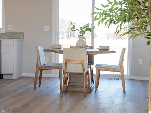 dining area with light hardwood / wood-style flooring