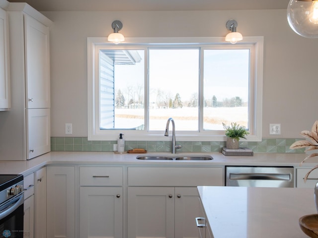 kitchen featuring white cabinets, stainless steel appliances, and sink