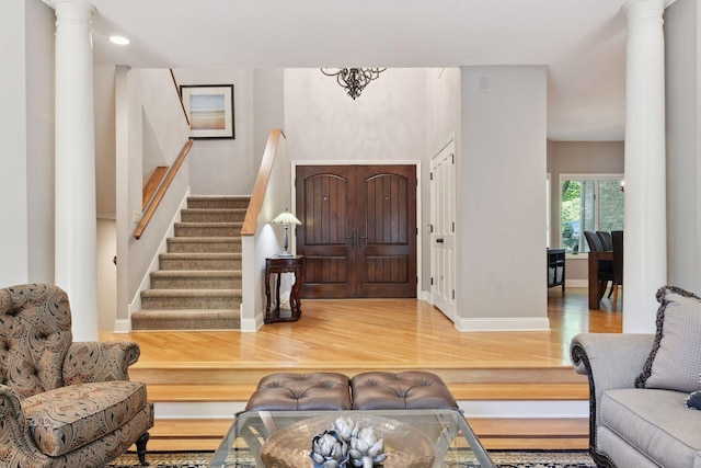 foyer with decorative columns and hardwood / wood-style flooring