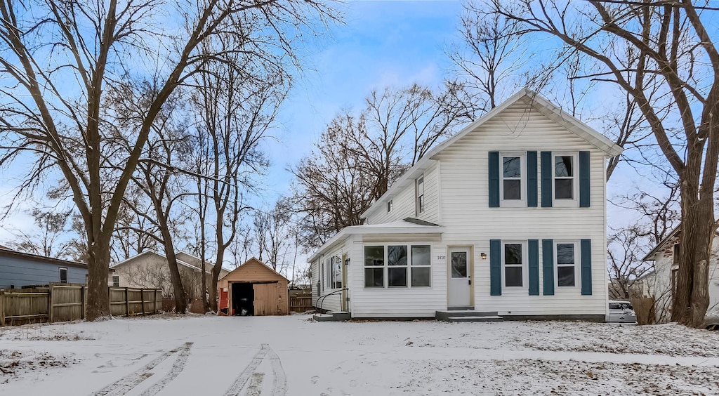 view of front of home with a storage shed