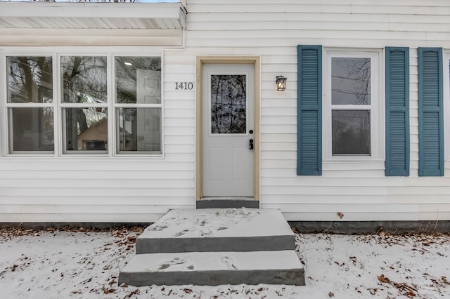 view of snow covered property entrance