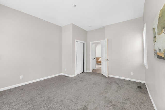 unfurnished bedroom featuring a closet and carpet