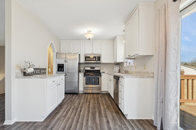 kitchen with white cabinets, appliances with stainless steel finishes, and a sink