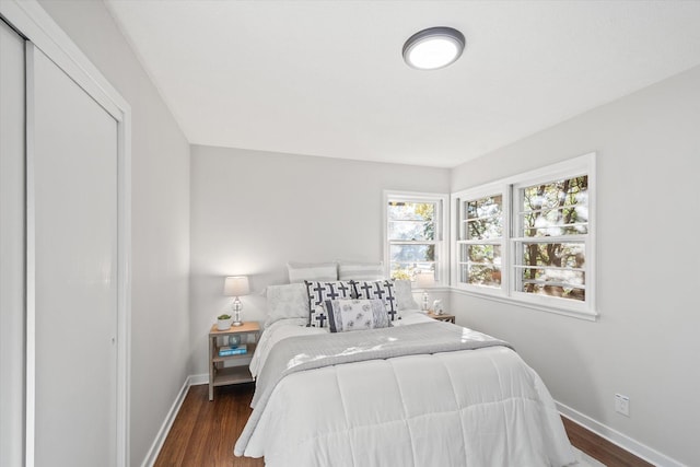 bedroom with dark hardwood / wood-style floors