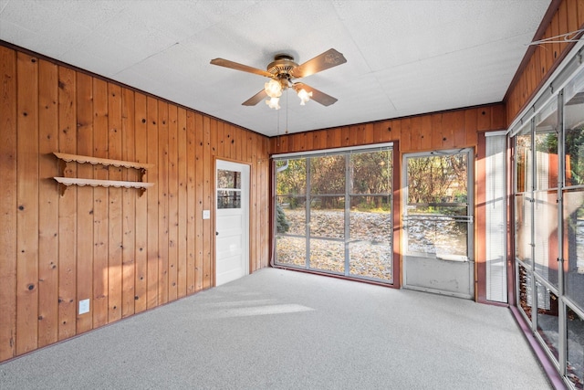 unfurnished sunroom featuring ceiling fan