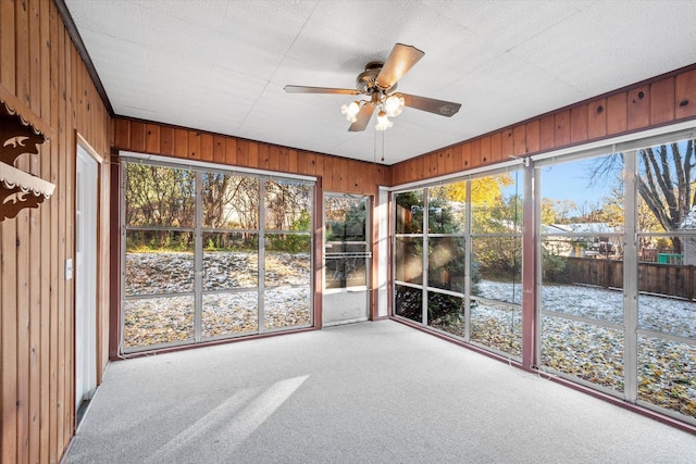 unfurnished sunroom with ceiling fan