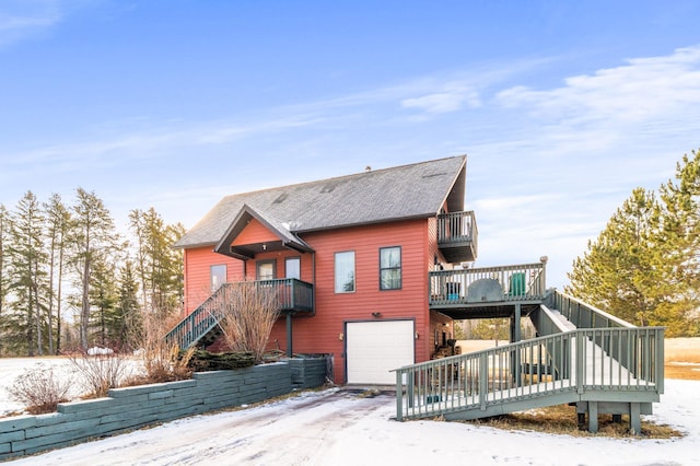 exterior space with a wooden deck and a garage