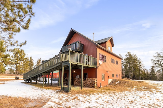 snow covered property featuring a deck