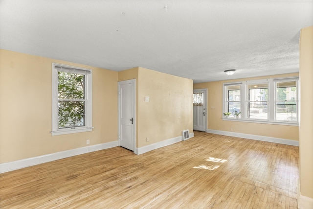 spare room featuring light hardwood / wood-style floors