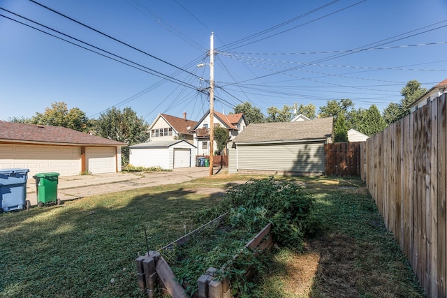 view of yard with a garage and an outdoor structure