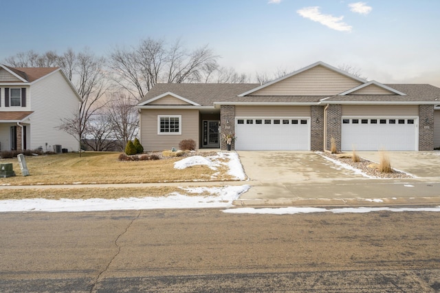 view of front of property featuring a garage and a front lawn