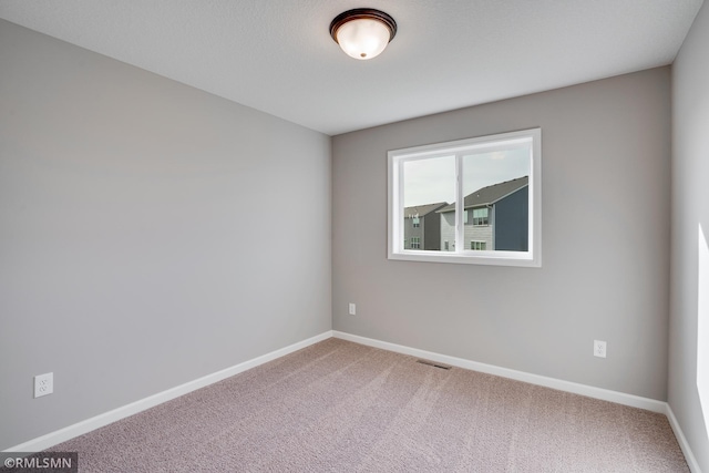 unfurnished room featuring carpet floors