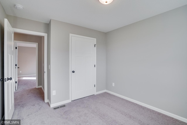 unfurnished bedroom with light colored carpet