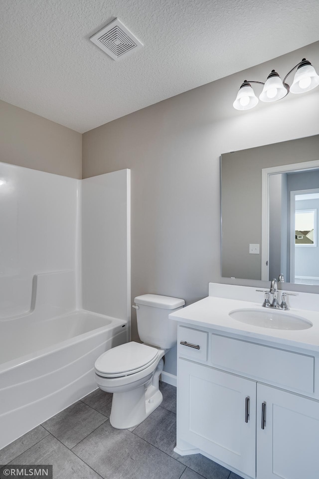 full bathroom with shower / bath combination, vanity, a textured ceiling, tile patterned floors, and toilet