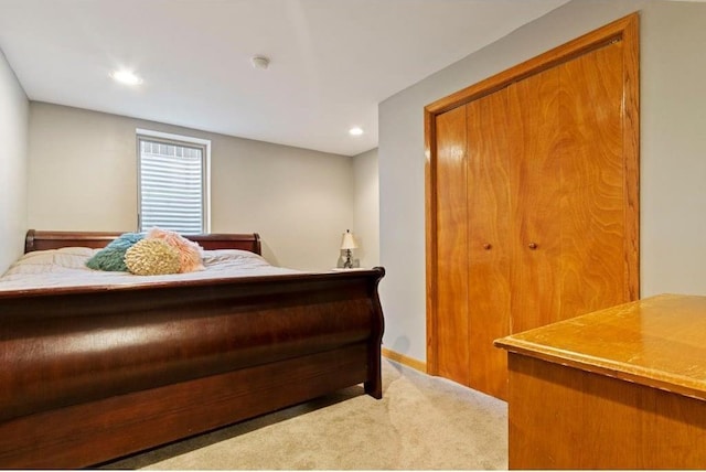 bedroom featuring light colored carpet and a closet