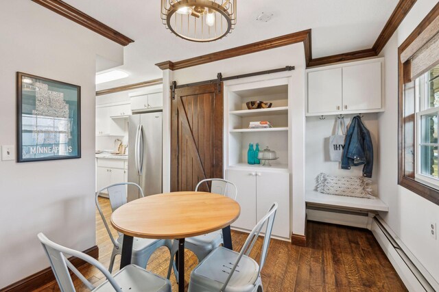 dining space featuring dark hardwood / wood-style flooring, a barn door, a wealth of natural light, and a baseboard heating unit