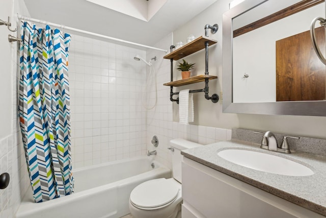 full bathroom featuring shower / tub combo, vanity, toilet, and tile walls