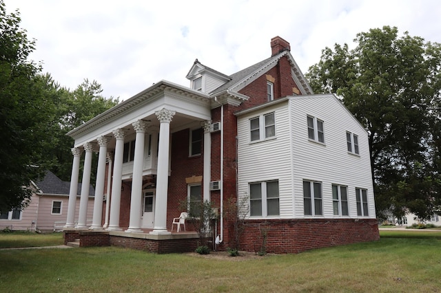 neoclassical / greek revival house featuring a front yard